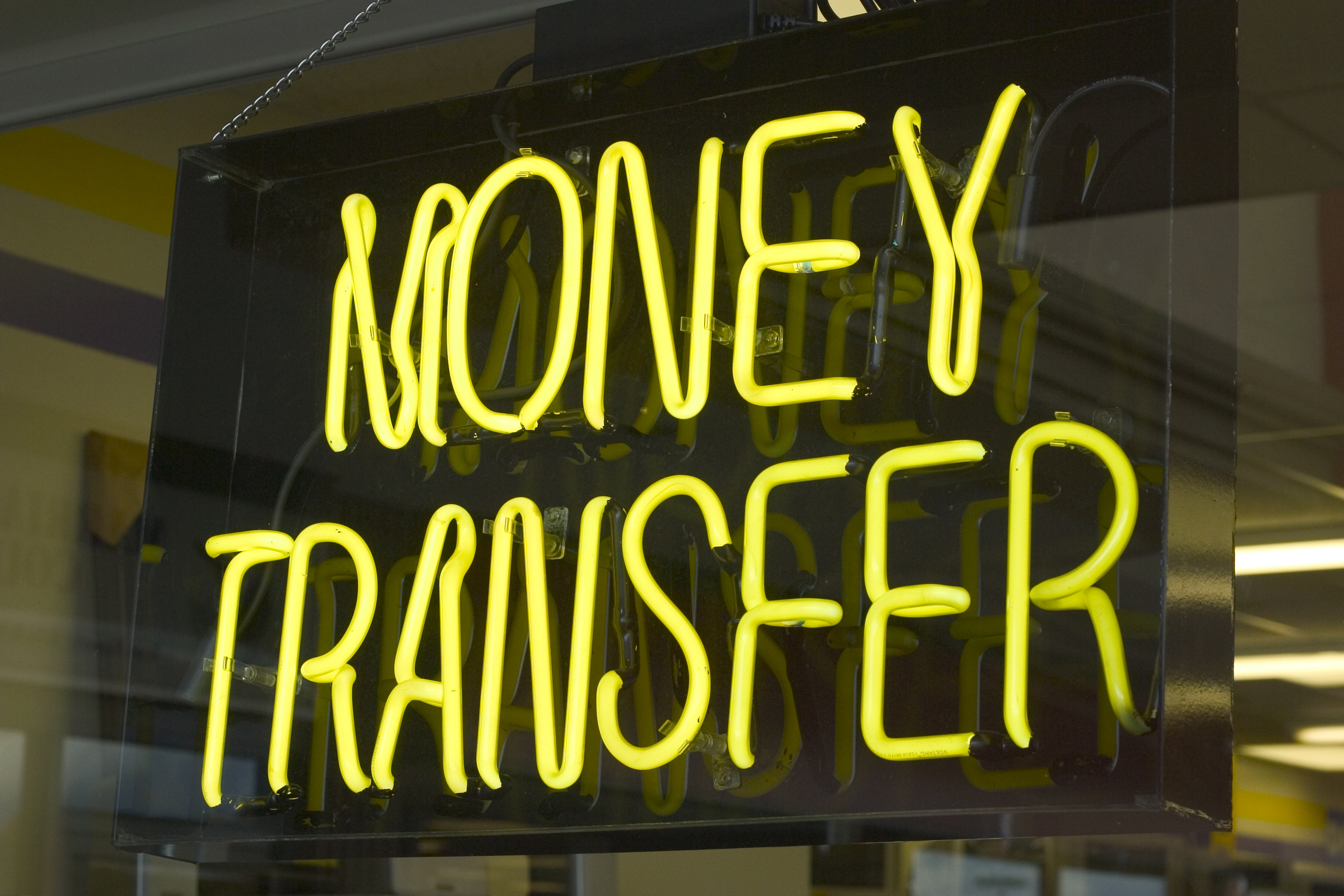 Neon sign depicting money transfer.